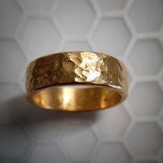 This is a thick and hefty solid 24k gold band with a hammered finish. The ring is approximately 8 MM wide. Very wide! 24k gold is relatively soft, but the thickness and irregular handmade finish make this ring wearable. This is a serious chunk of gold, and the color of real 24k gold really has no match, it is absolutely beautiful. Even if you look for one, there are not many rings available like this. Also, I can make this in 22k gold, which is slightly more durable and less expensive. Just ask Gold Bands Made Of Recycled Gold, Gold Bands Made From Recycled Gold, Gold Recycled Gold Bands, Gold Recycled Gold Promise Ring Bands, Gold Recycled Gold Bands For Promise Ring, Gold Hammered Thick Band Ring, Gold Hammered Wide Band Ring, Gold Hand Forged Jewelry With Thick Band, Hand Forged Gold Jewelry With Thick Band