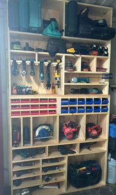 a garage filled with lots of tools and storage bins on top of wooden shelves