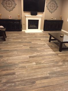 a living room with wood flooring and fireplace