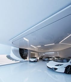 two white sports cars parked in a garage next to each other and some stairs leading up to them