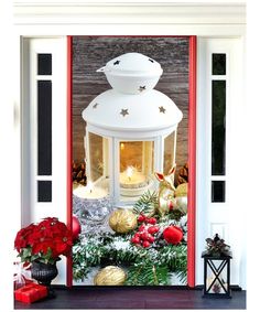 christmas decorations and candles are displayed in front of a house's entry door, decorated for the holiday season