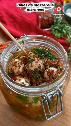 a glass jar filled with food on top of a wooden table