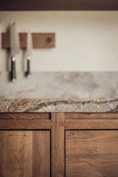 a kitchen counter with two knives on it