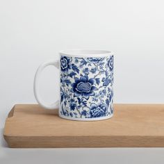 a blue and white mug sitting on top of a wooden table