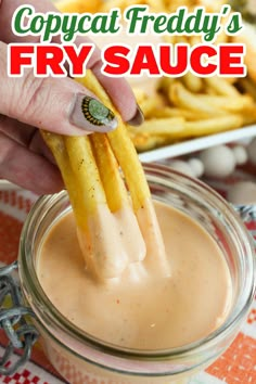 a person dipping french fries into a sauce in a jar with the words copycat friday's fry sauce