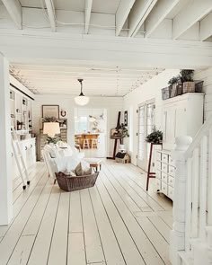 a living room with white walls and wooden floors