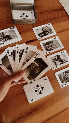 a person is playing cards on a table