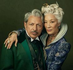 an older man and woman pose for a portrait