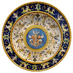 a blue and gold plate with animals on it