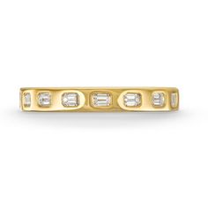 a yellow gold ring with three baguettes and four diamonds on the side, set in