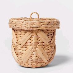 a woven basket with wooden handles on a white background