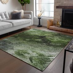 a living room with a white couch and green rug