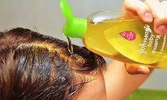 the woman is drying her hair with shampoo and an olive oil in front of her head