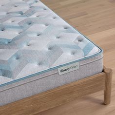 an image of a mattress that is on the bed frame in the room with wood flooring