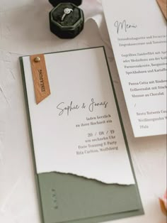 the wedding stationery is laid out on the table