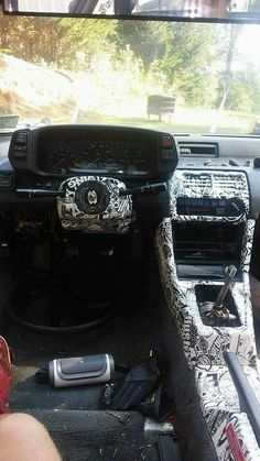 the interior of a car with various items in it