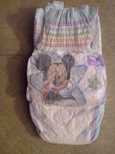 a diaper with a mickey mouse design on it's side and some stars around the bottom