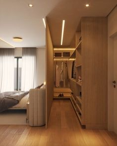 a bedroom with wooden flooring and built - in closets next to a bed