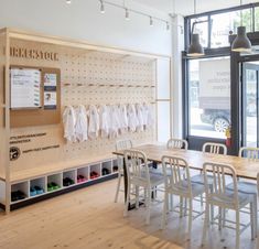 the inside of a store with wooden tables and chairs