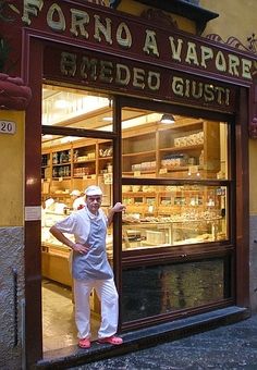 a man standing in front of a store window