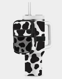 a black and white cow print bottle holder with an insulated cup in the middle