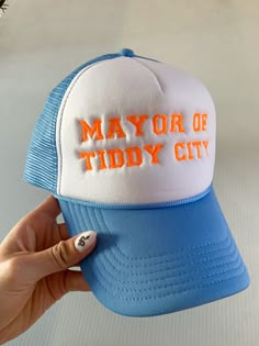 "MAYOR OF TIDDY CITY" FOAM TRUCKER EMBROIDERED HAT Photo features baby blue cap with orange thread Adjustable Hat Size Woman Trucker Hat, Trucker Hat Patch Design, Foam Trucker Hats, Trendy Trucker Hat, Trendy Trucker Hats For Women, Trucker Hat Funny, Vinyl Trucker Hats, Unhinged Trucker Hats, Embroidered Trucker Hats