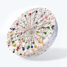 an umbrella made out of marbles and pins