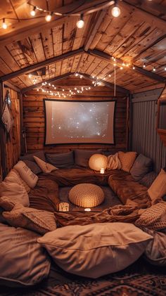 a living room filled with lots of pillows and lights