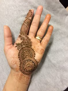 a woman's hand with henna tattoos on it