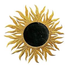 a black and gold sunburst on a white background