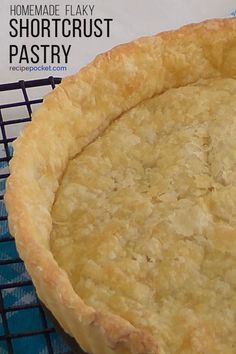 a homemade flaky shortcrust pastry sitting on a cooling rack next to a box of shortcrust pastry