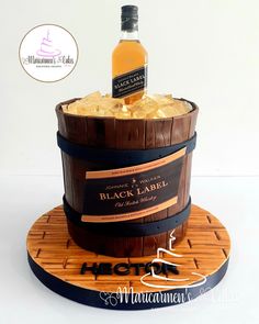 a bottle of black label whiskey in a wooden barrel