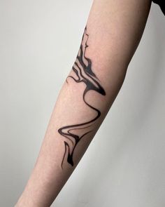 a woman's arm with a black and white tattoo design on the left forearm