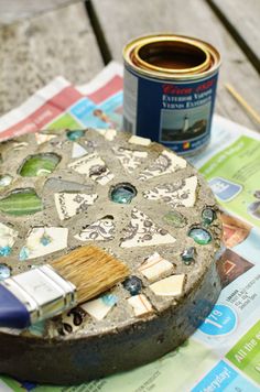 a paint can and brush sitting on top of a table