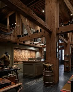 a large room with wooden walls and beams on the ceiling is filled with wood furniture