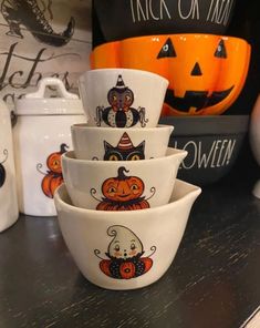 halloween themed dishes are stacked on top of each other, with pumpkins in the background