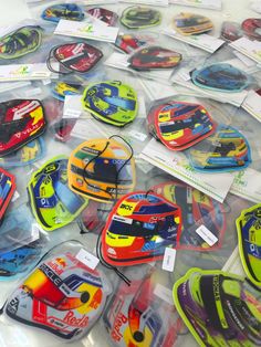 assorted race car shaped magnets are on display