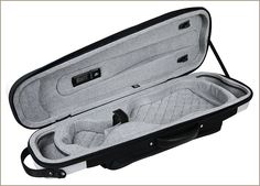 an open suit case sitting on top of a white floor next to a black handle