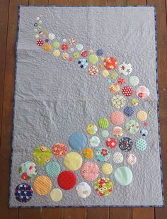 a quilted wall hanging with buttons on it