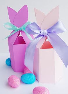 three candy boxes with bows and candies around them