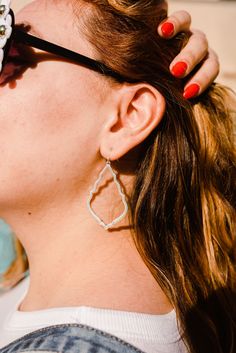 a close up of a person wearing some kind of earrings