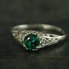 "Emerald Ring Cinderella Lab Grown Emerald May Birthstone Ring Silver Engagement Ring Promise Ring Filigree Emerald Ring Vintage Style Ring \"If you keep on believing, the dream that you wish will come true\" Cinderella sparks memories of glass slippers, fairy god mothers, and dancing until midnight. This is her ring...dainty, intricate and as stunning as can be! A detailed filigree setting securely holds a 5mm genuine Lab Grown Chatham Created Emerald. It is surrounded by intricate vining filig Antique Emerald Ring With Center Stone, Emerald Rings With Intricate Design For Anniversary, Heirloom Solitaire Emerald Ring, Classic Crystal Birthstone Ring For Formal Occasions, Emerald Ring With Intricate Design, Heirloom Emerald Ring With Intricate Design For Anniversary, Filigree Ring For May Birthstone Gift, May Birthstone Filigree Ring Gift, Elegant Emerald Promise Ring With Round Stone