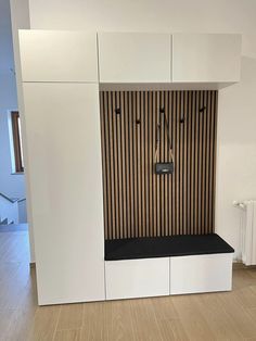 an empty room with white cabinets and black accents