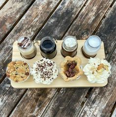 a wooden tray topped with different types of desserts