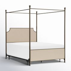 a bed with a white mattress and beige headboard is shown in this image, it's made from metal