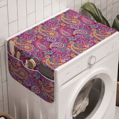 a washer and dryer sitting next to each other in front of a tiled wall