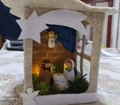 a nativity scene is displayed on a table