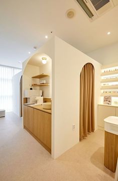 the interior of a store with shelves and counter tops on either side of the room