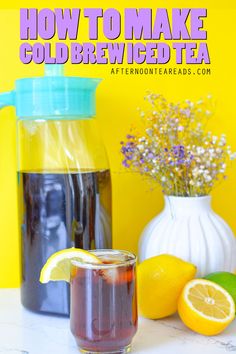 a pitcher of iced tea next to some lemons