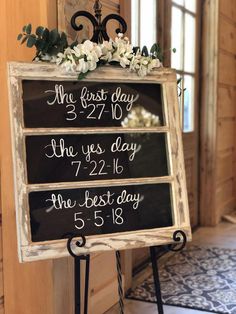 a sign that says the first day and two years ago with flowers on it in front of a door